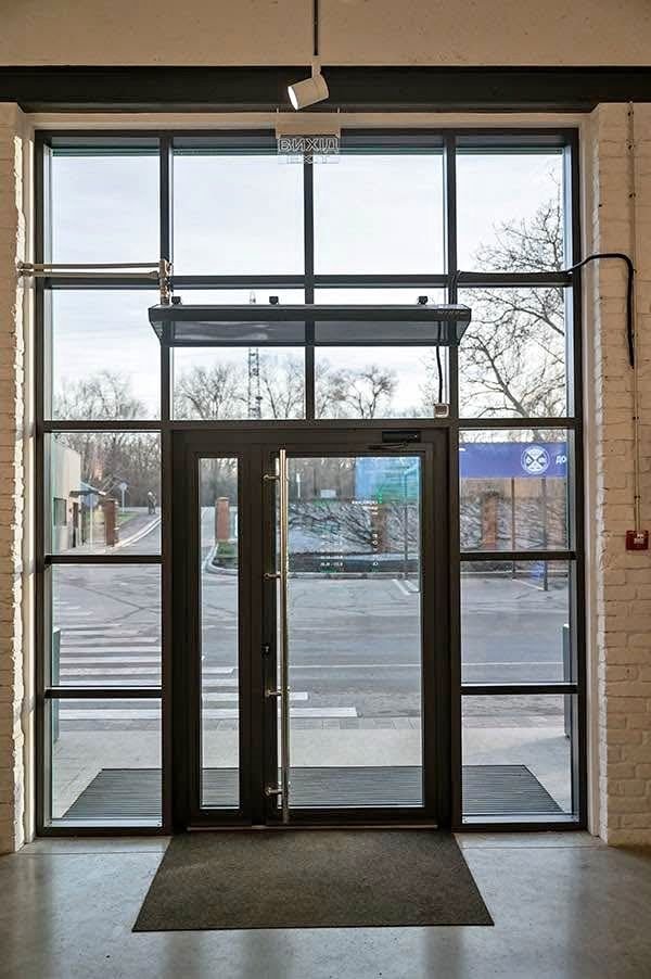 Aluminum storefront entrance with glazed sidelights and transom